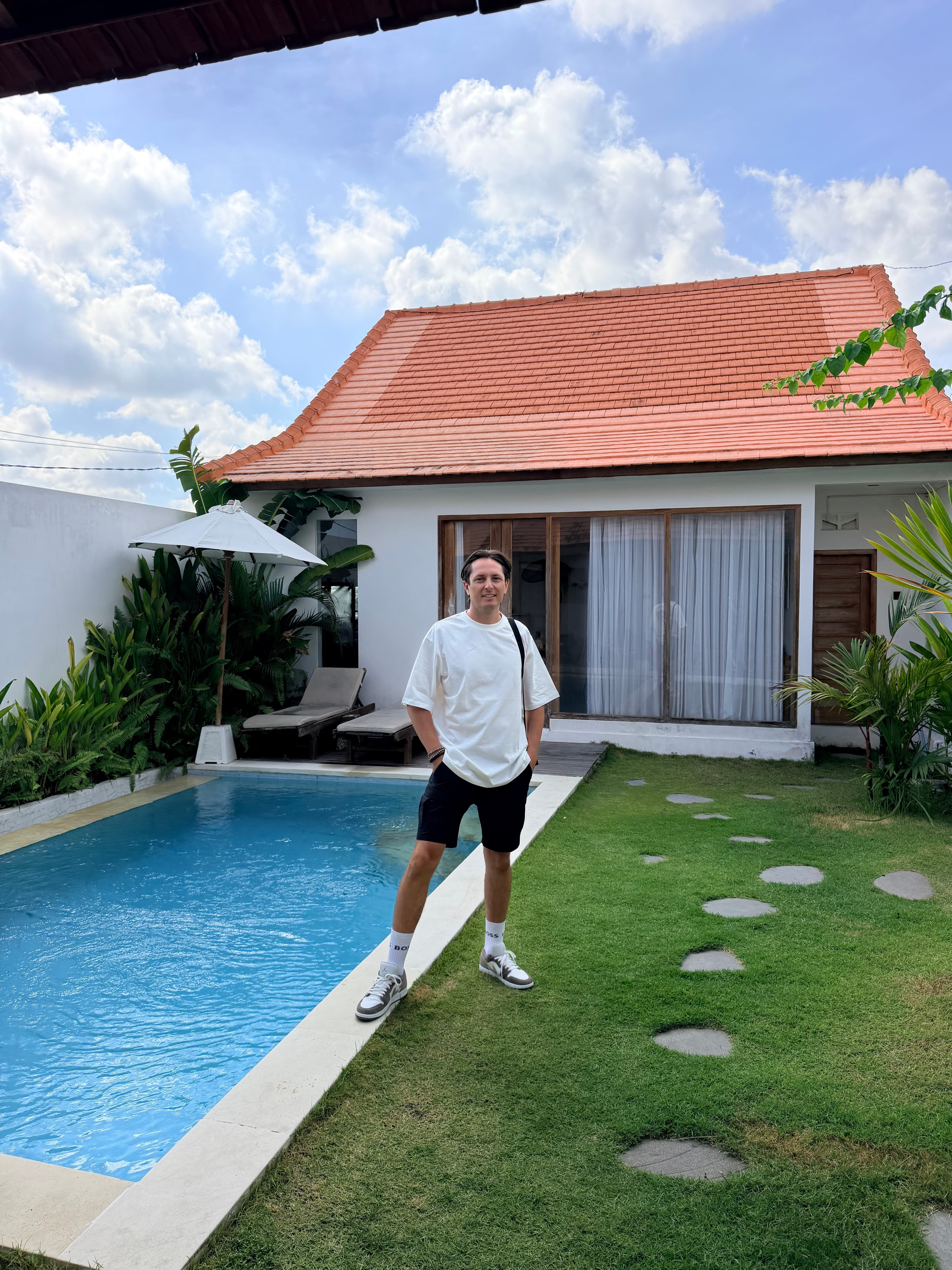 Dmitry Kosolapov standing beside the pool at a Bali villa