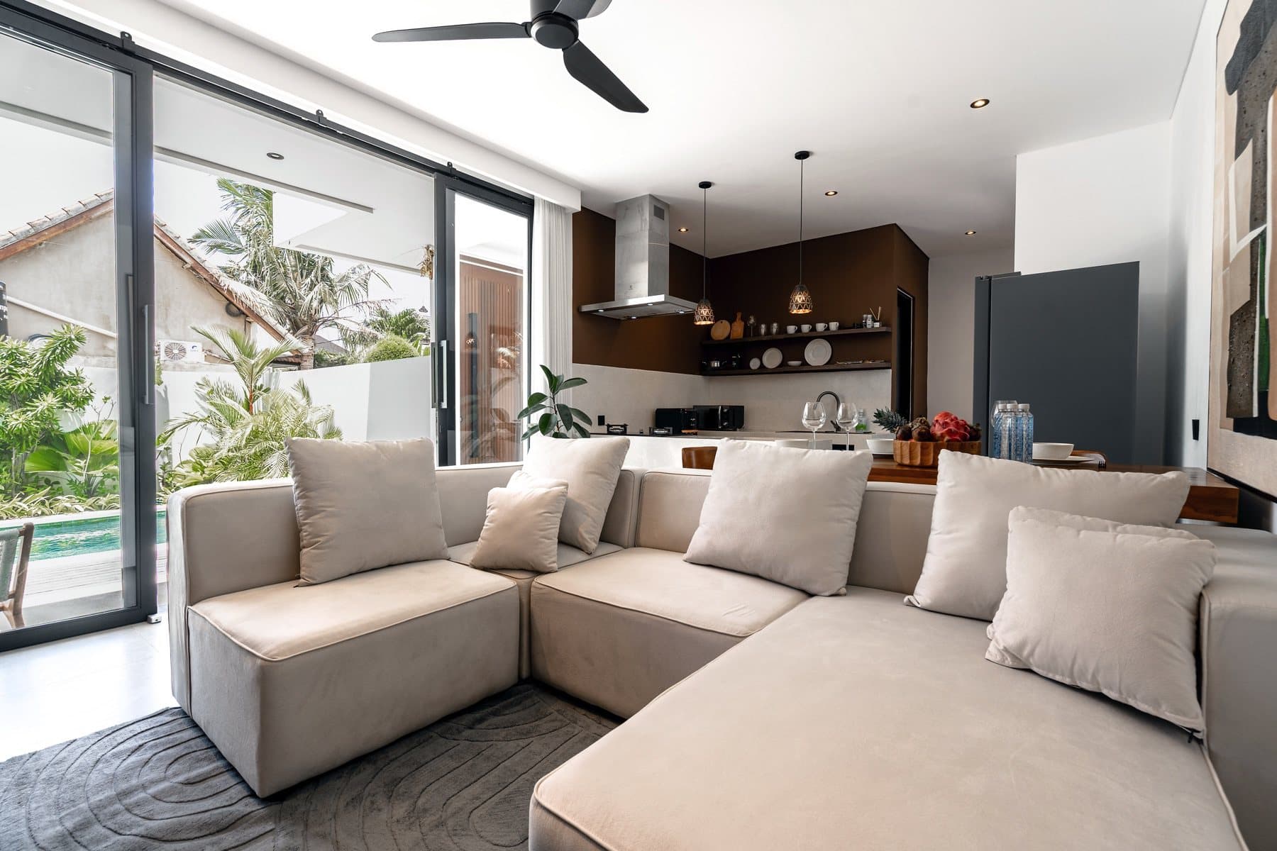 Completed shared space with an equipped kitchen, dining table and sofa