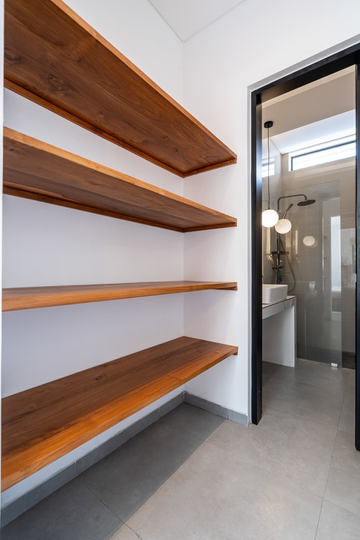Wooden shelves in the niche next to the bathroom