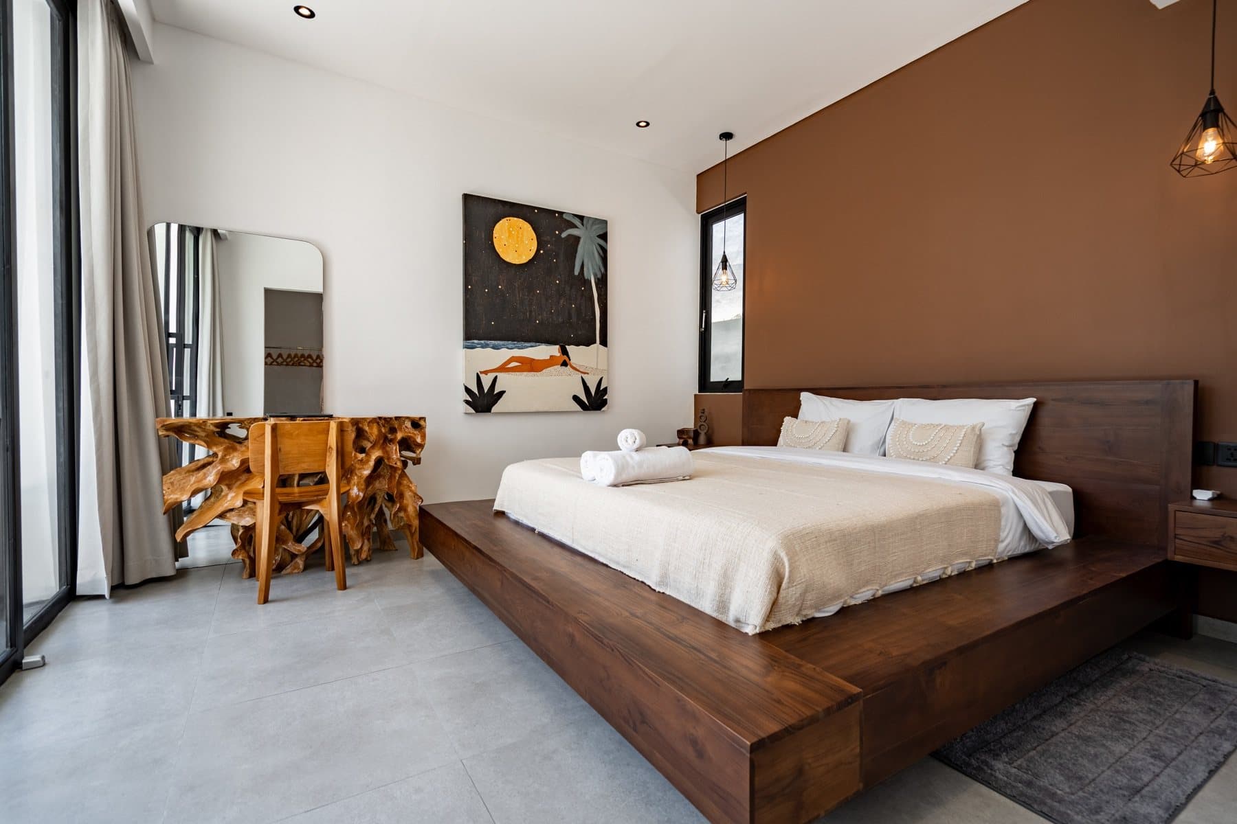 Bedroom with a wooden bed, sculptural console and artwork