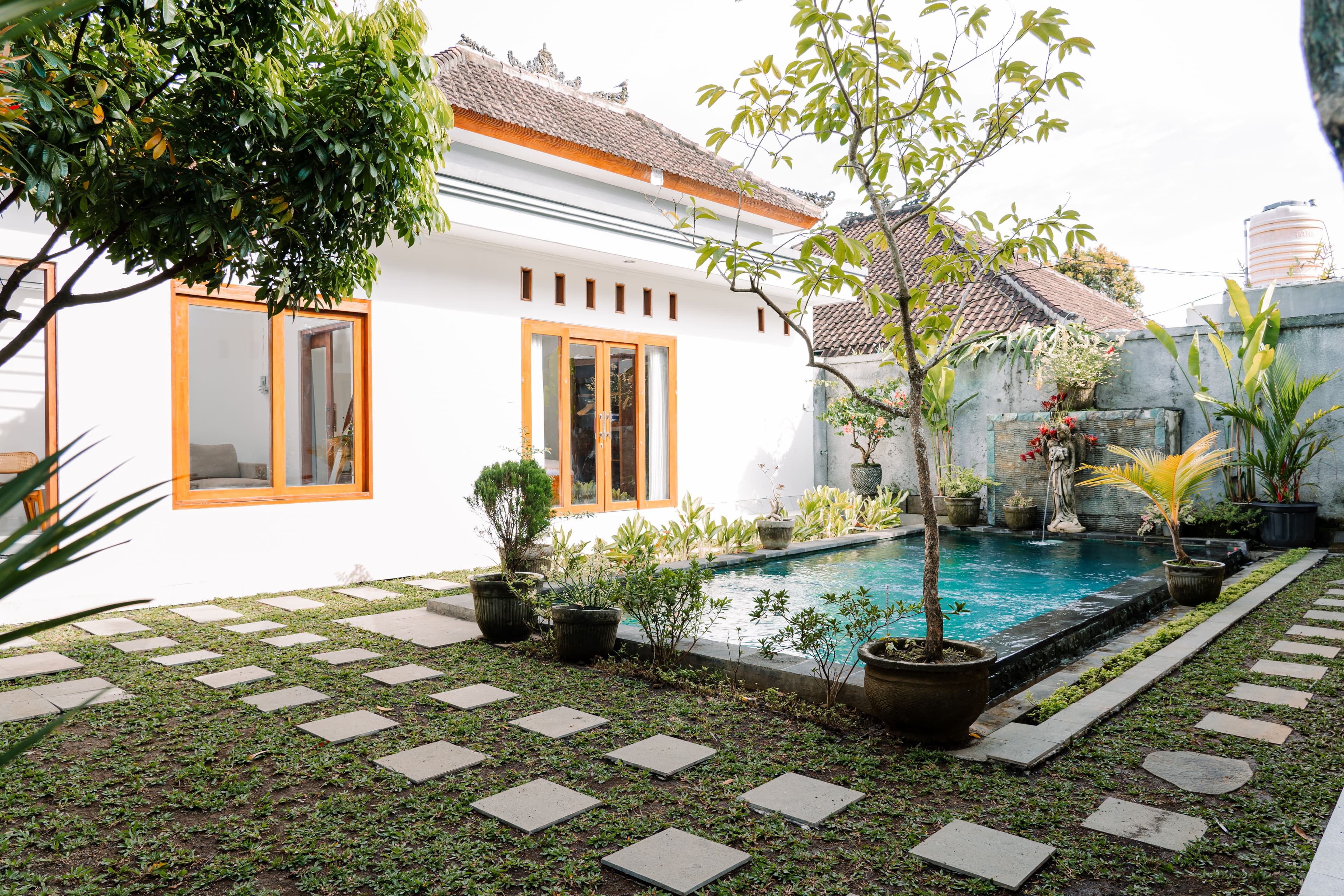 ATELIERO-managed Bali villa exterior with pool and tropical garden